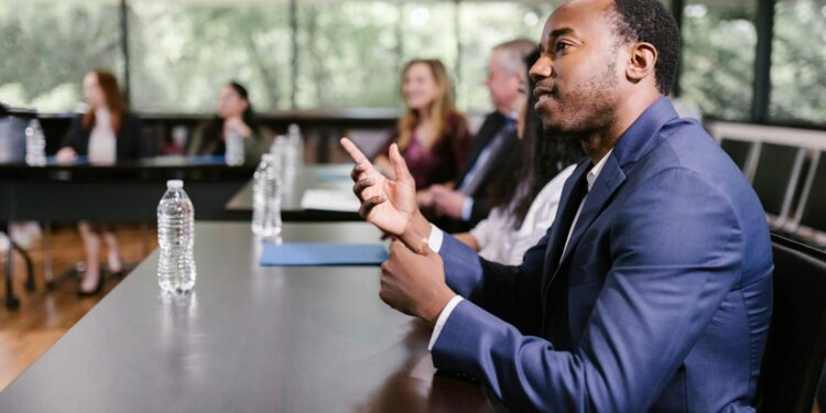 A group of bankers discussing cryptocurrency regulations around a conference table.