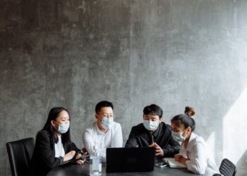 OpenAI representatives discussing child safety measures at a conference table.