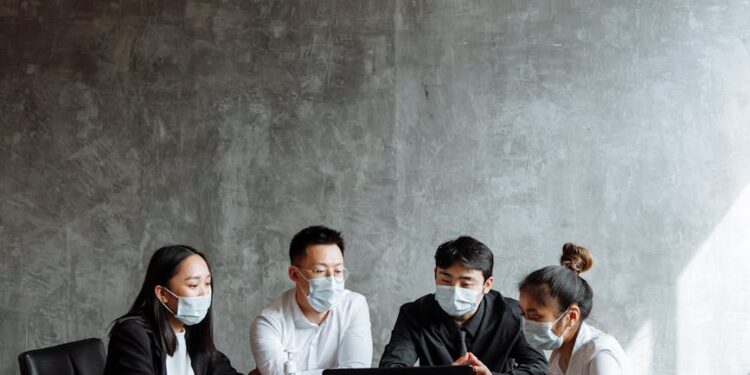 OpenAI representatives discussing child safety measures at a conference table.