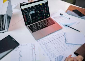 Politicians examine documents related to insider trading allegations in finance.