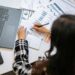 A business professional analyzing cryptocurrency regulations at a desk with financial reports.