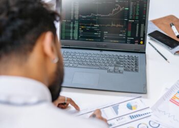 State employees analyze data on financial regulations and prediction markets in a meeting room.