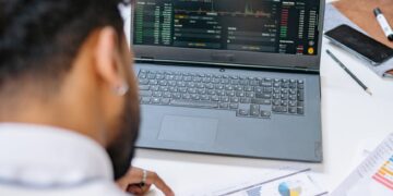 State employees analyze data on financial regulations and prediction markets in a meeting room.
