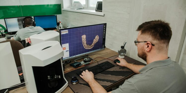 A technician analyzes gemstones with advanced AI software in a lab setting.