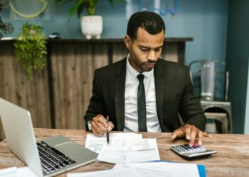 A businessman checking stablecoin account balances on a laptop.
