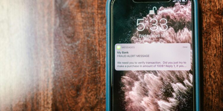 A close-up of a smartphone displaying a DeFi app with an alert notification on security.
