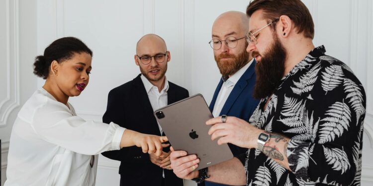 A fintech team discussing digital payment connections and regulatory updates at a conference.