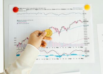 Investor hands exchanging Bitcoin with a financial graph in the background, symbolizing capital inflows.