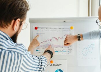 Aave team discusses crypto strategy in front of financial charts and data analytics.
