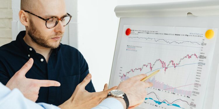 Two state employees discussing regulations with a prediction market chart in the background.