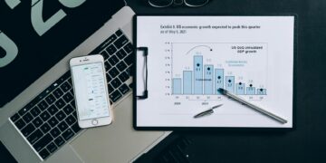 Goldman Sachs logo with a backdrop of digital currency graphics and financial charts.