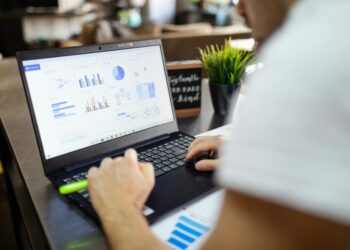 Computer screen displaying Claude Mythos report highlights and vulnerability charts.