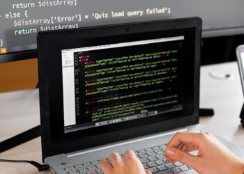 A developer using a laptop to code a personal data scrubber tool on a digital screen.