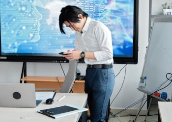 Two business professionals discussing AI technology in a modern office setting.