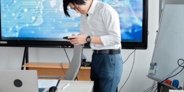 Two business professionals discussing AI technology in a modern office setting.