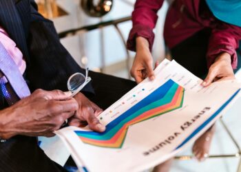 A diverse group of finance professionals reviewing cryptoasset regulatory documents.