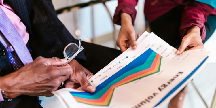 A diverse group of finance professionals reviewing cryptoasset regulatory documents.