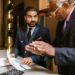 Finance professionals discuss IPO plans at a conference table with charts and documents.