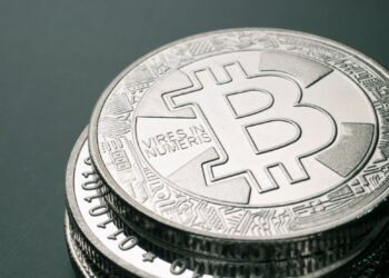 Stacks of digital currency tokens with a burning effect, symbolizing token burn strategy.