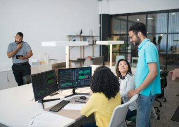 A futuristic office space with diverse team members discussing AI and blockchain technology.