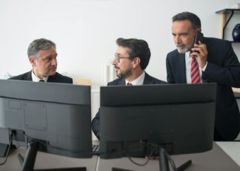 Bank representatives discussing stablecoin regulations in a modern office setting.