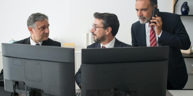 Bank representatives discussing stablecoin regulations in a modern office setting.