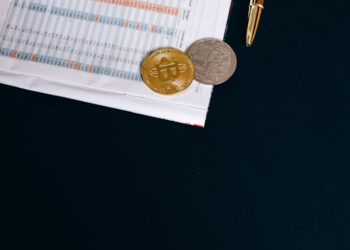 A cryptocurrency exchange office with a digital currency display and financial documents.