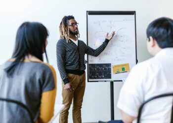 A diverse group of professionals engages in a blockchain education workshop.