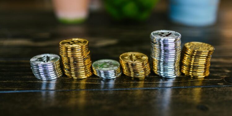 Stacks of coins and digital currency icons illustrating stablecoins and crypto regulations.