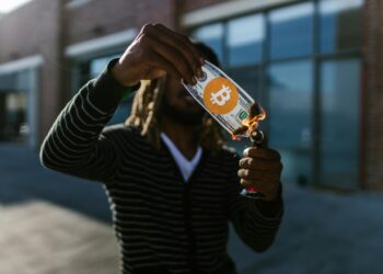 Graphic showing cryptocurrency burn event with flames and USR tokens in the background.