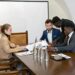 A diverse group of leaders at a conference discussing blockchain and finance innovations.