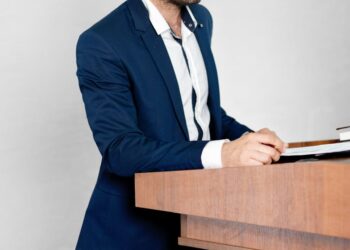 SEC Chair Gary Gensler speaks at a podium about cryptocurrency regulation.