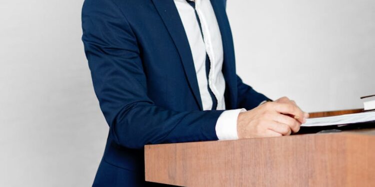 SEC Chair Gary Gensler speaks at a podium about cryptocurrency regulation.