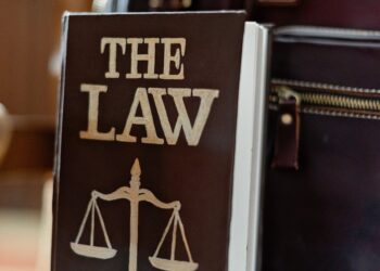 A courtroom with legal books and papers, emphasizing the xAI lawsuit against Senate Bill 24-205.