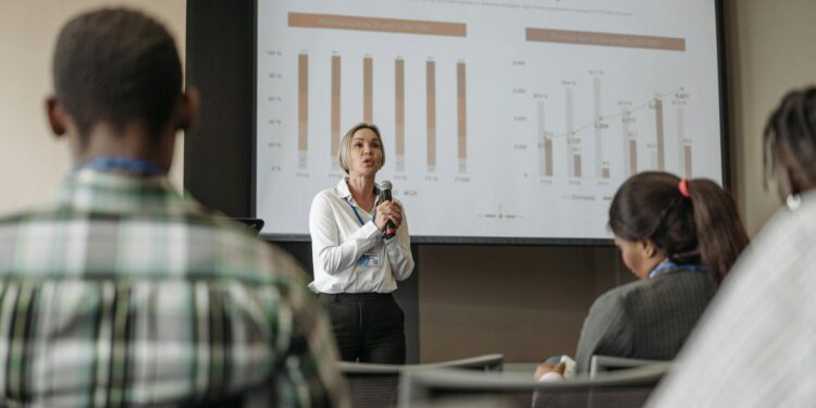 Sam Altman speaking at a conference, with graphs and charts on AI investments in the background.