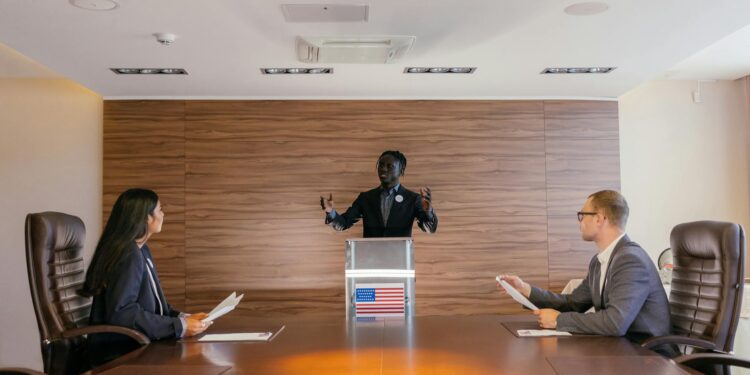 Politician discussing AI dividend proposal with displaced workers in a conference setting.