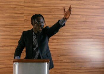 Trump gestures emphatically at a podium, discussing Iranian power plant tensions during a speech.