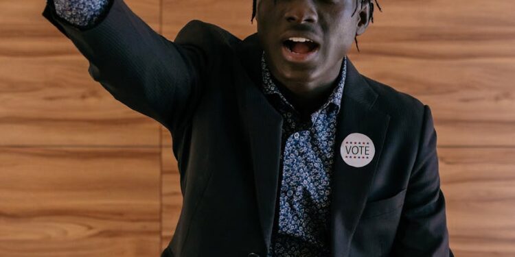 David Woodcock speaking at a podium with SEC logo, addressing crypto regulation issues.