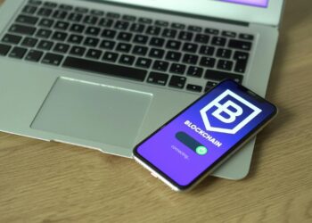 A smartphone displaying a fake Ledger Live app with a bitcoin balance dwindling to zero.
