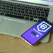 A smartphone displaying a fake Ledger Live app with a bitcoin balance dwindling to zero.