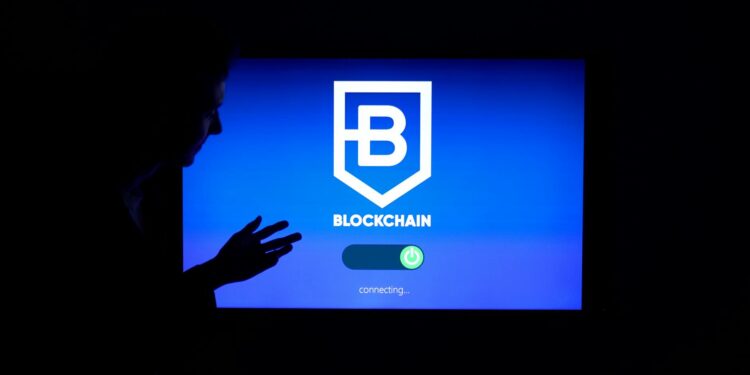A researcher stands before a digital screen displaying Bitcoin and quantum computing graphics.