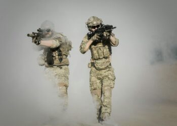 Troops using advanced AI technology for military targeting operations.