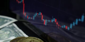 Judge's gavel with cryptocurrency symbols and financial charts in the background.