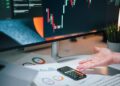 A financial expert analyzing cryptocurrency regulations and sanctions risks at a desk.