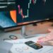 A financial expert analyzing cryptocurrency regulations and sanctions risks at a desk.