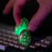 A visual representation of cryptocurrency thefts, with a dark hacker silhouette and digital currency icons.
