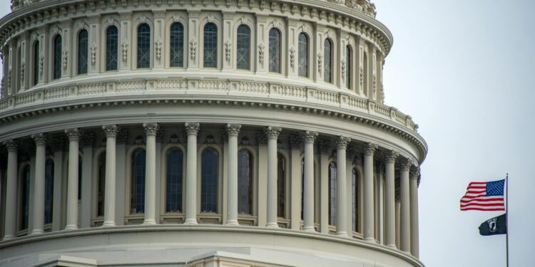Graphic showing the Coinbase logo with a U.S. Capitol building backdrop and stablecoin symbols.