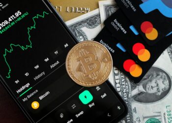 A user holding a credit card with cryptocurrency icons against a digital finance backdrop.