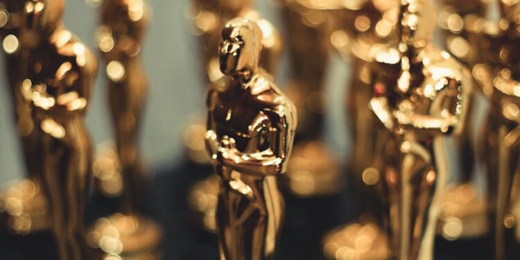 Red carpet at Oscars with film industry professionals discussing AI content regulations.