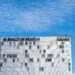 Brazilian bank building with digital currency symbols and a ban sign overlay.